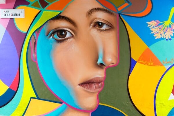 Colorful digital art close-up of woman's face with geometric patterns representing digital identity