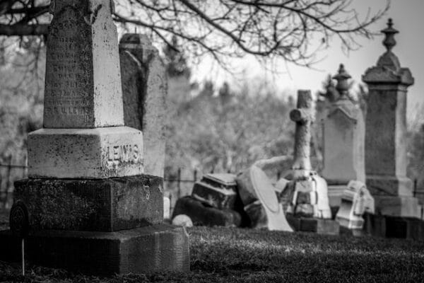Black and white graveyard photograph with headstones and monuments