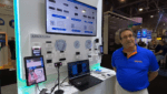 Trade show booth showcasing facial recognition and biometric scanning technology from a company called Armatura, with displays of facial imaging software, hardware devices, and a staff member wearing the company’s branded shirt.