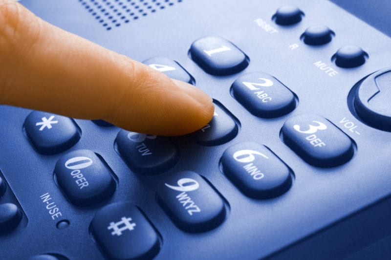 finger with green phone keypad